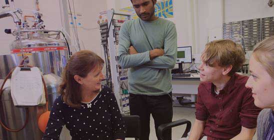 A group of people in a lab talking with the CDT director